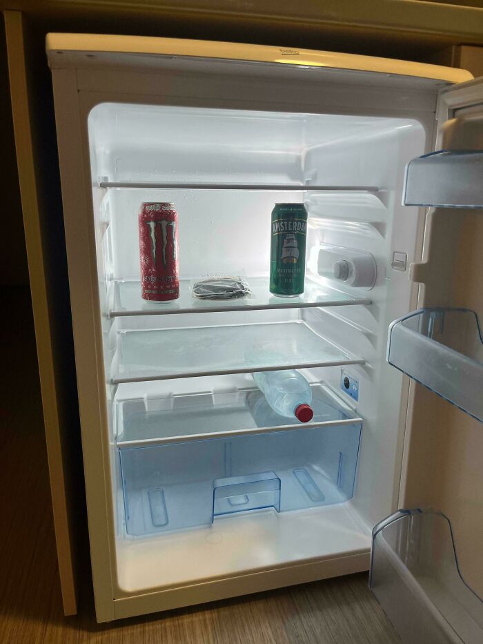 Minimal fridge contents with drinks and a small snack showcasing interesting fridge contents not matching Pinterest aesthetic vibe.
