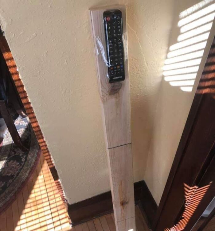 Remote control taped to a wooden plank mounted on a wall as a simple example of if it's stupid but it works then it's not stupid.