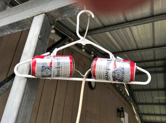 Clothes hanger reinforced with crushed beer cans demonstrating clever examples of if it's stupid but it works then it's not stupid.