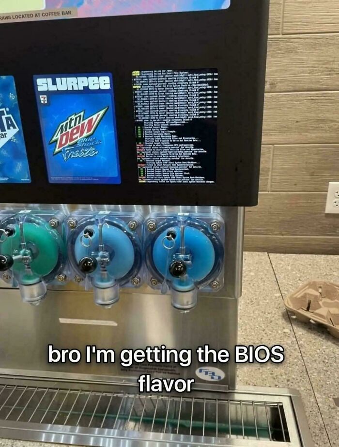 Slurpee machine screen showing a BIOS error next to Mountain Dew flavor dispenser with humorous caption about BIOS flavor.