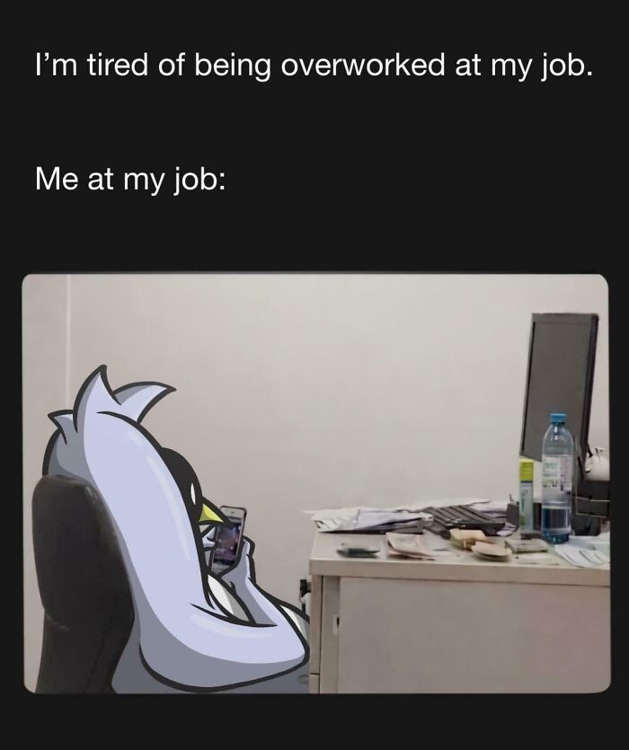 Cartoon penguin relaxing on a chair using a phone at a messy desk, illustrating relatable work memes humor.