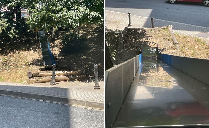 A small playground slide ending abruptly at a street, illustrating terrible product design that makes no sense.
