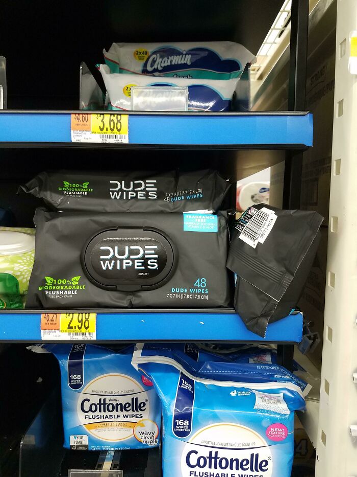 Packages of DUDE wipes and Cottonelle flushable wipes displayed on store shelves highlighting gendered nonsense products.