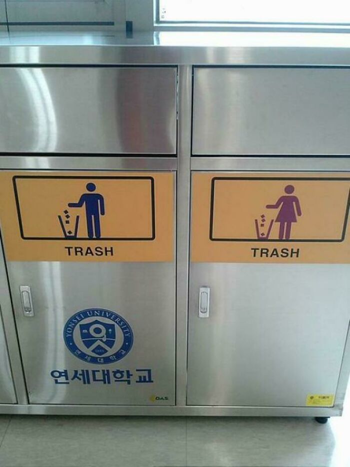 Gendered nonsense on trash bins with separate male and female icons on stainless steel bins at a university.
