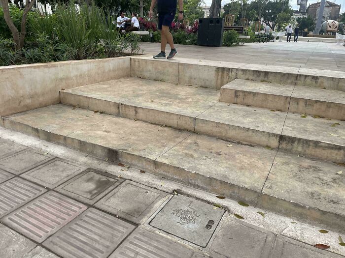 Concrete stairs with inconsistent step heights and uneven design creating a confusing product design flaw outdoors.