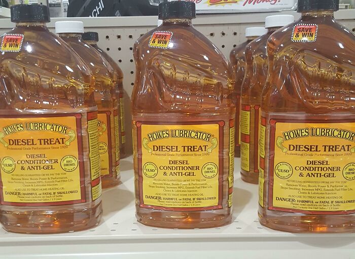 Rows of diesel conditioner bottles with confusing packaging design on a store shelf showcasing terrible product designs.