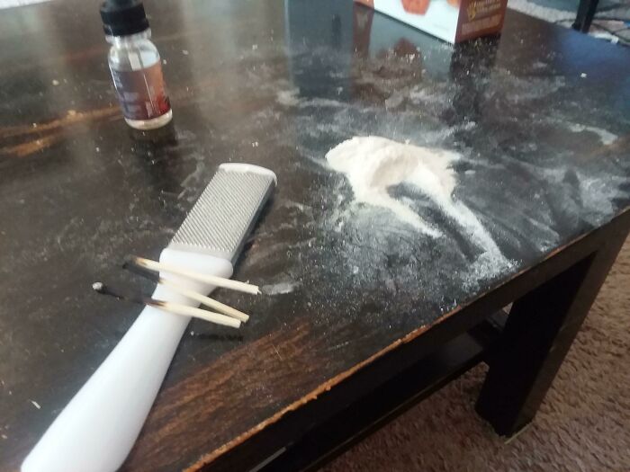 Messy table with spilled powder and personal items, illustrating jerks that made roommates consider working 5 jobs to live alone.