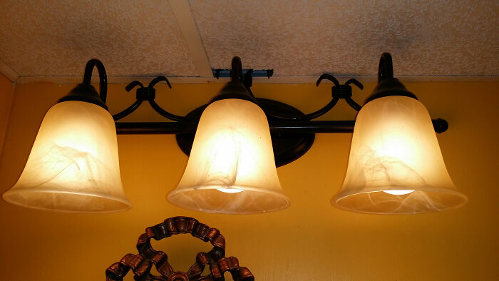 Three ceiling lights with uneven alignment, highlighting a classic example of DIY fail in home lighting installation.