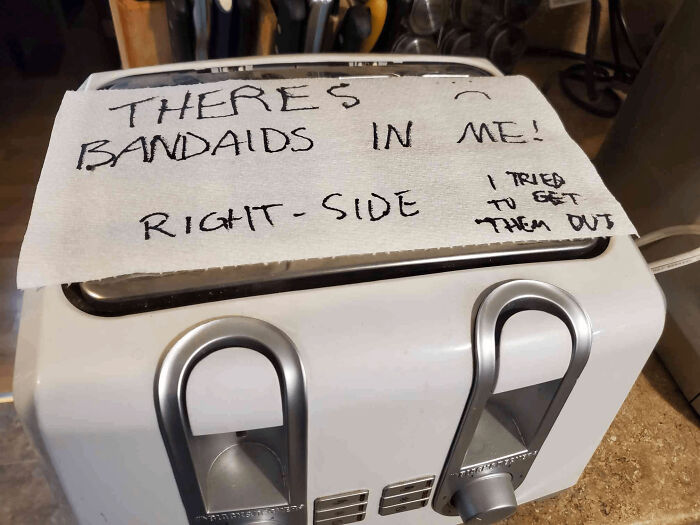 Toaster with a note about band-aids stuck inside, illustrating a roommate jerk causing frustration.
