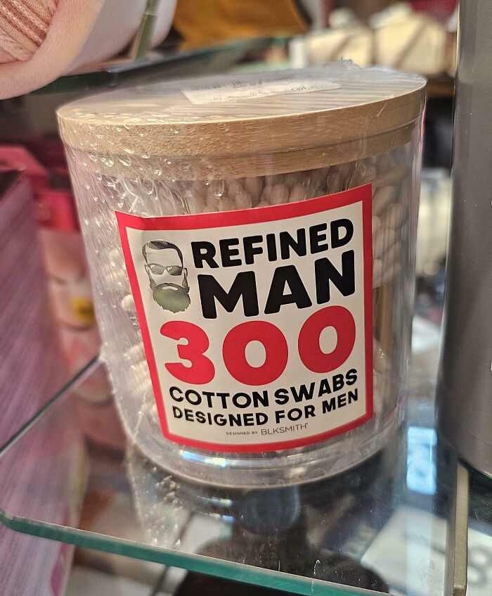 Container of cotton swabs labeled refined man 300, highlighting gendered nonsense in product marketing for men.