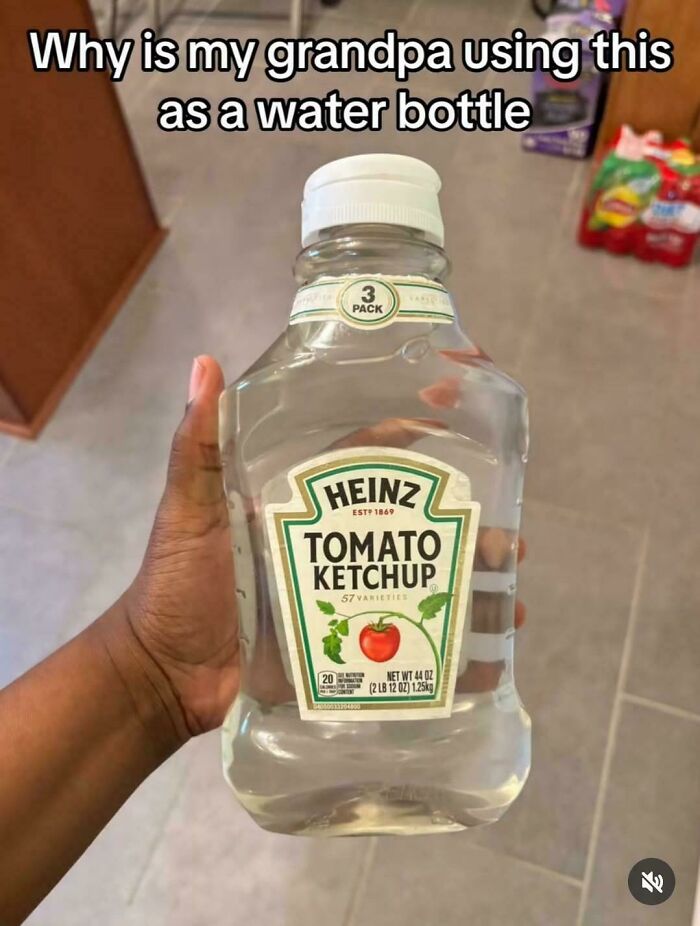Hand holding a Heinz ketchup bottle filled with water, highlighting a funny screenshot about using ketchup as a water bottle.
