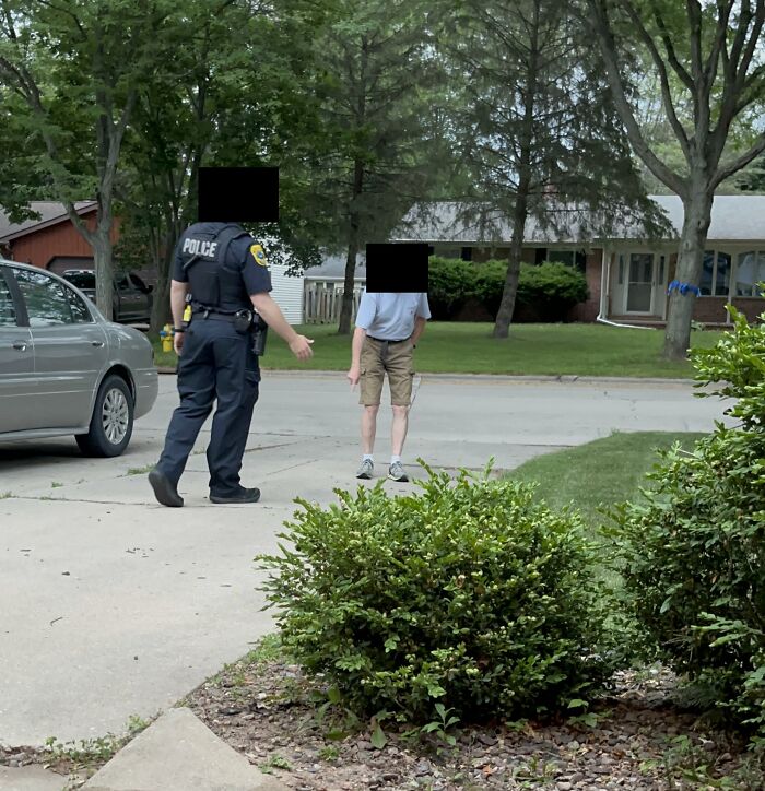 Police officer talking to a man outside a suburban home, illustrating roommate conflicts making others consider living alone.
