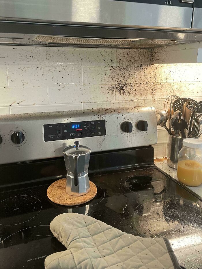 Stove and backsplash splattered with coffee grounds, showing an infuriating example of men being men in the kitchen.
