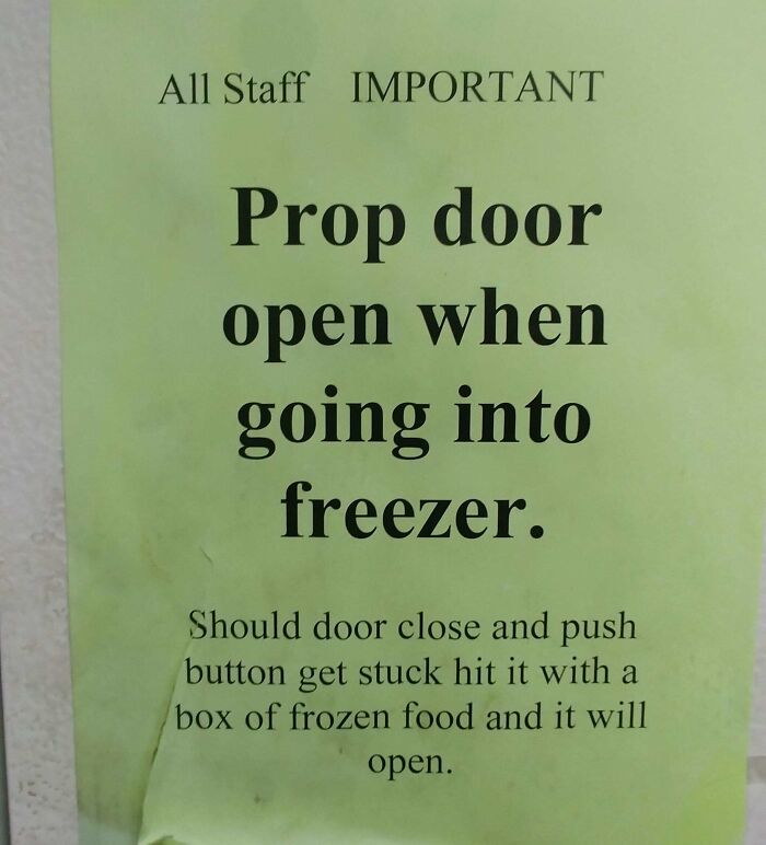 Sign instructing staff to prop door open when entering freezer, highlighting reckless work moments for safety awareness.