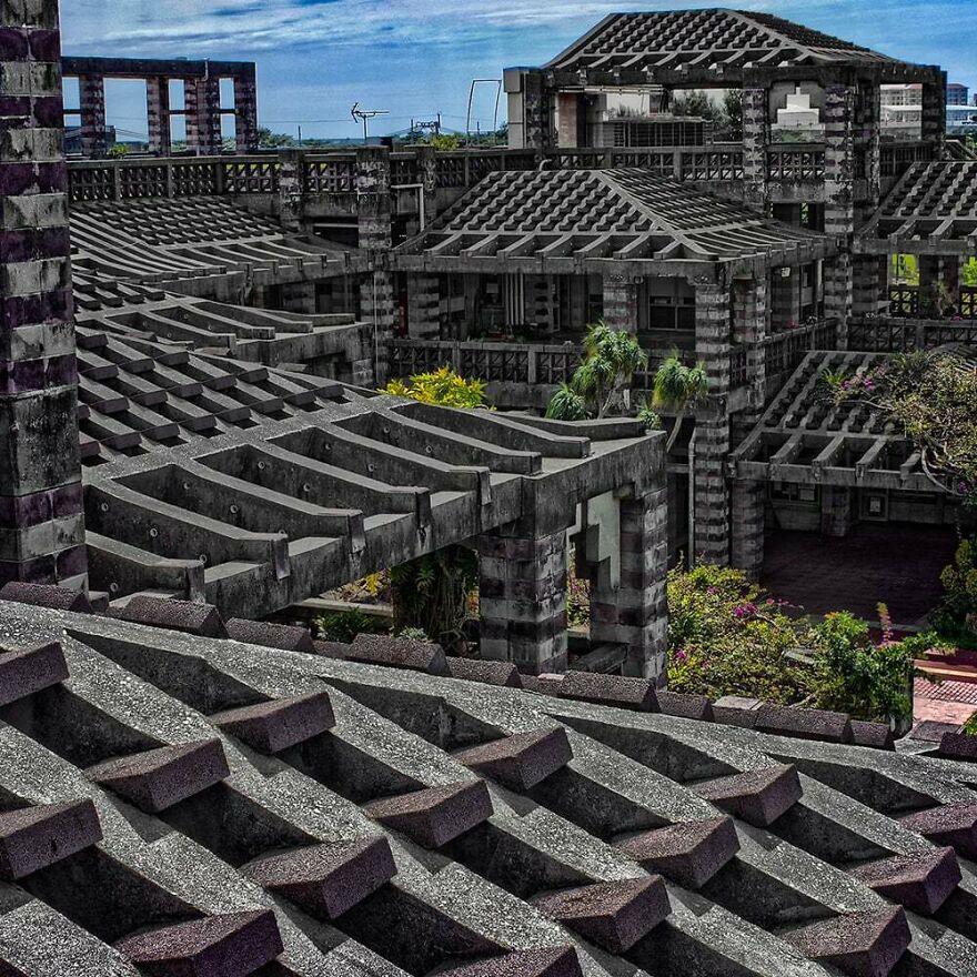 Concrete structures with intricate lattice patterns and greenery showcasing unique Japanese architecture design elements.