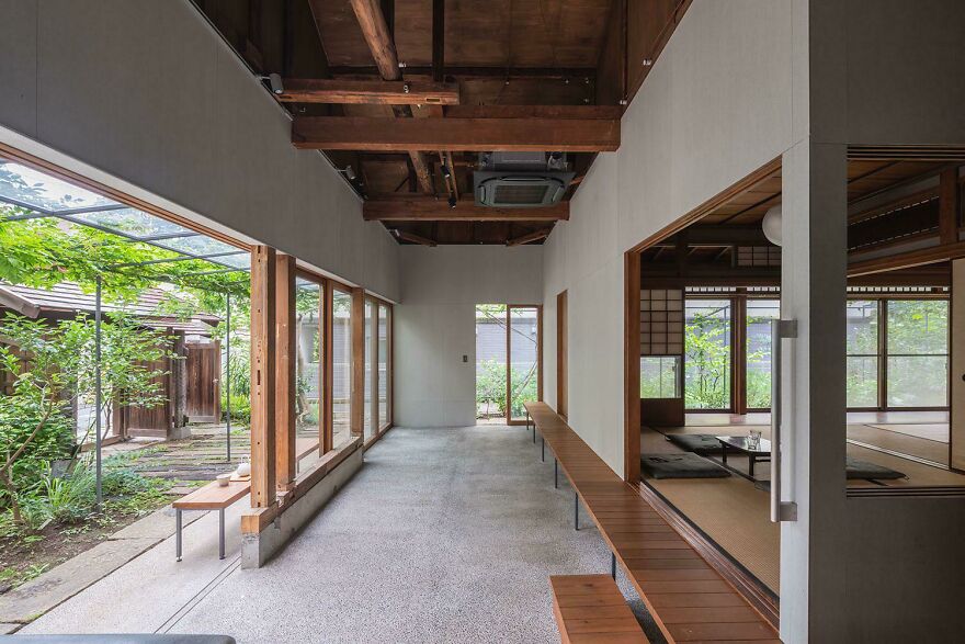 Minimalist Japanese architecture interior with wooden beams, large windows, and a serene garden view in a traditional style.