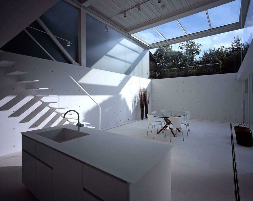 Minimalist interior with natural light from skylight, showcasing modern and interesting examples of Japanese architecture design.