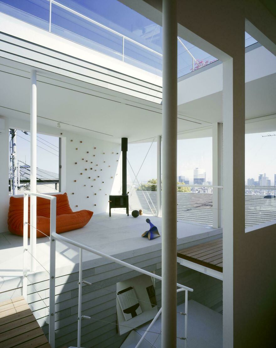 Modern open living area in a Japanese architecture home featuring minimalist design and large windows with city views.