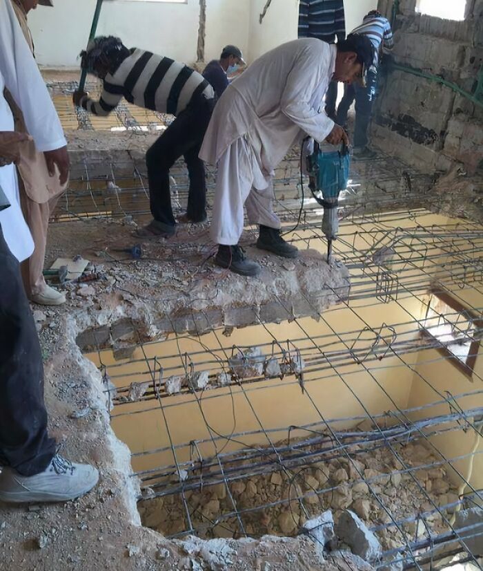 Workers using power tools dangerously on an unstable floor with exposed rebar in reckless work moments lacking safety measures