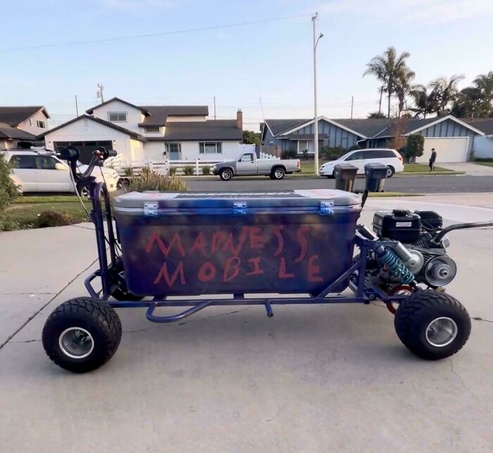 Homemade motorized cooler on wheels labeled madness mobile parked in a suburban driveway, showing creative if it's stupid but it works example.