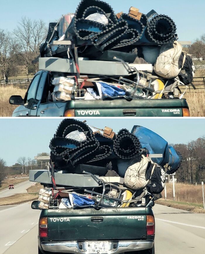 A Toyota Tacoma overloaded with numerous large items precariously stacked, illustrating dumb drivers on the road.