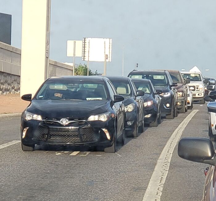 Multiple cars improperly lined up in traffic, illustrating examples of dumb drivers causing road congestion.
