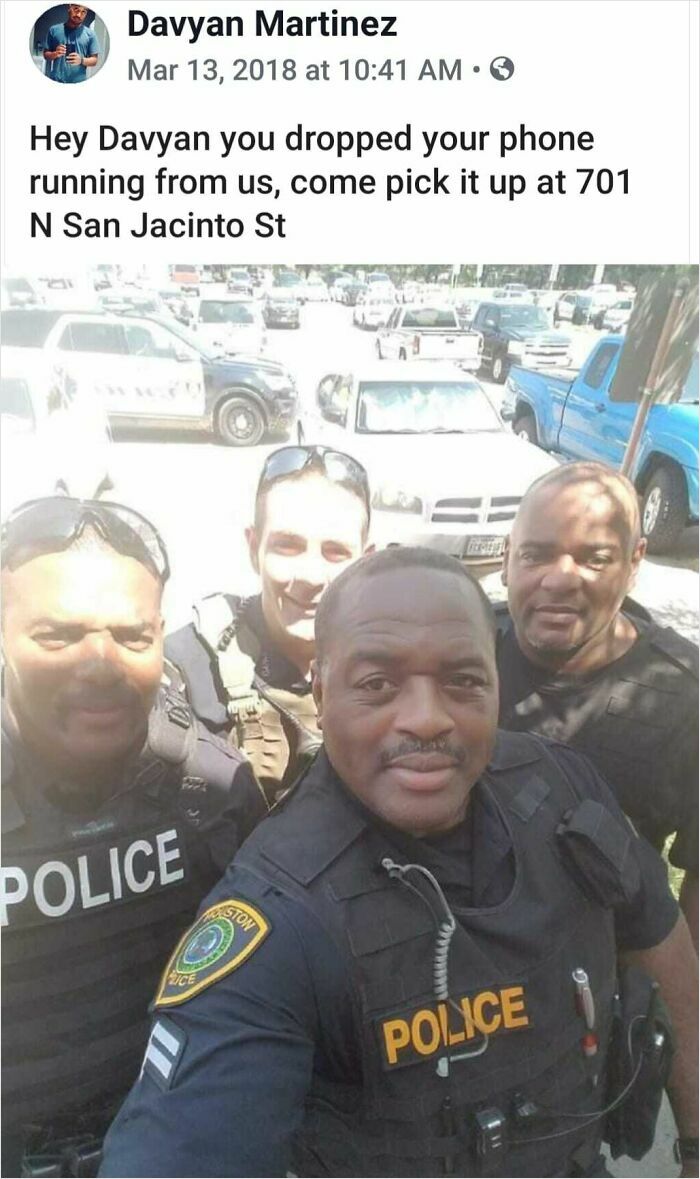 Four police officers smiling for a selfie in a parking lot with a humorous social media message about a lost phone.