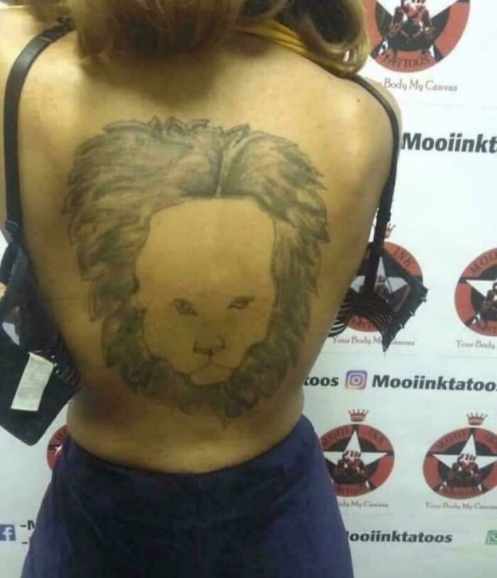 Large poorly drawn lion tattoo covering a woman’s back as an example of bad tattoos showing thinking first is optional.