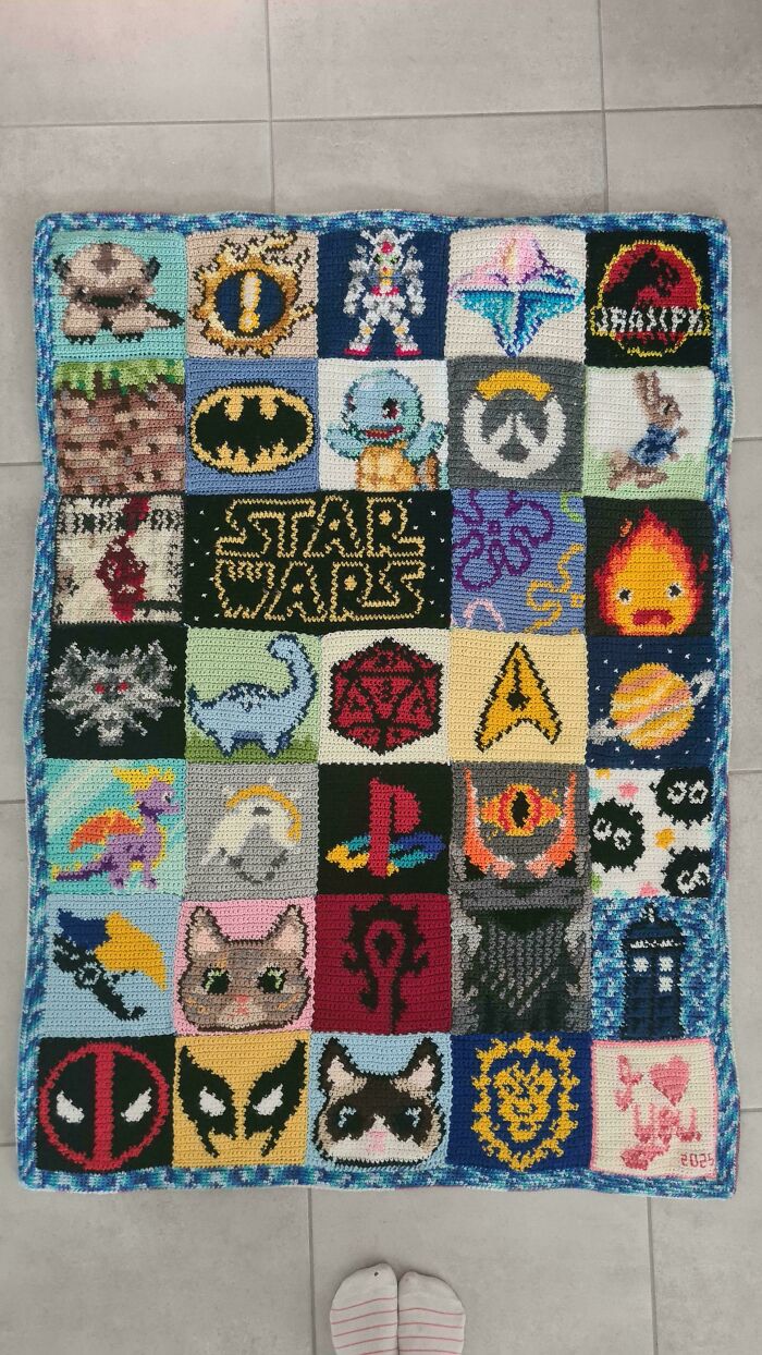 Awesome crocheted blanket with pop culture icons like Star Wars and Batman, showcasing incredible crochet artistry.