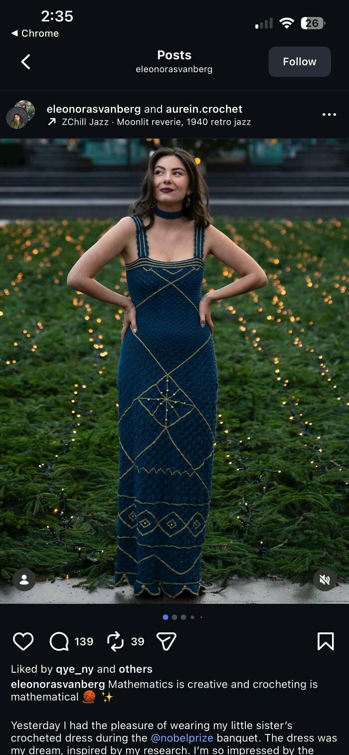 Woman wearing a stunning, awesome crocheted dress with golden patterns, standing outdoors amidst twinkling lights.