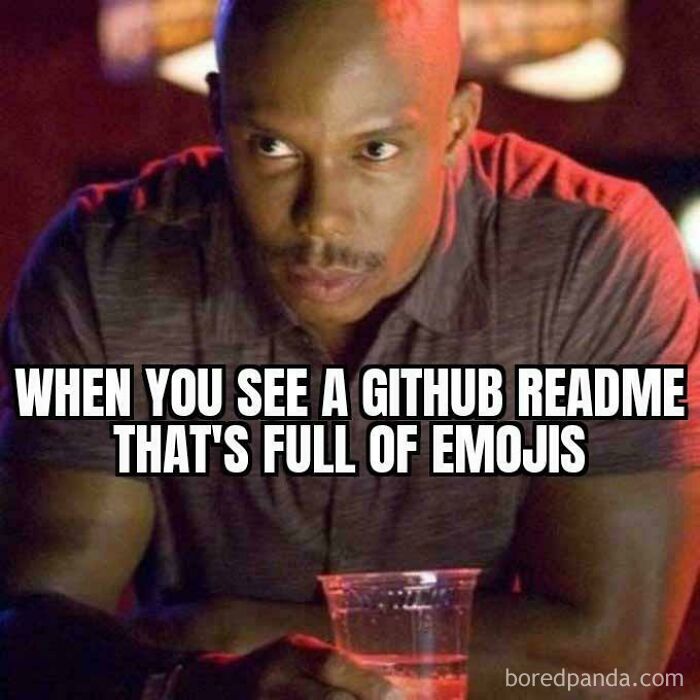 Man looking serious with a drink, captioned about seeing a Github readme full of emojis in programming memes.