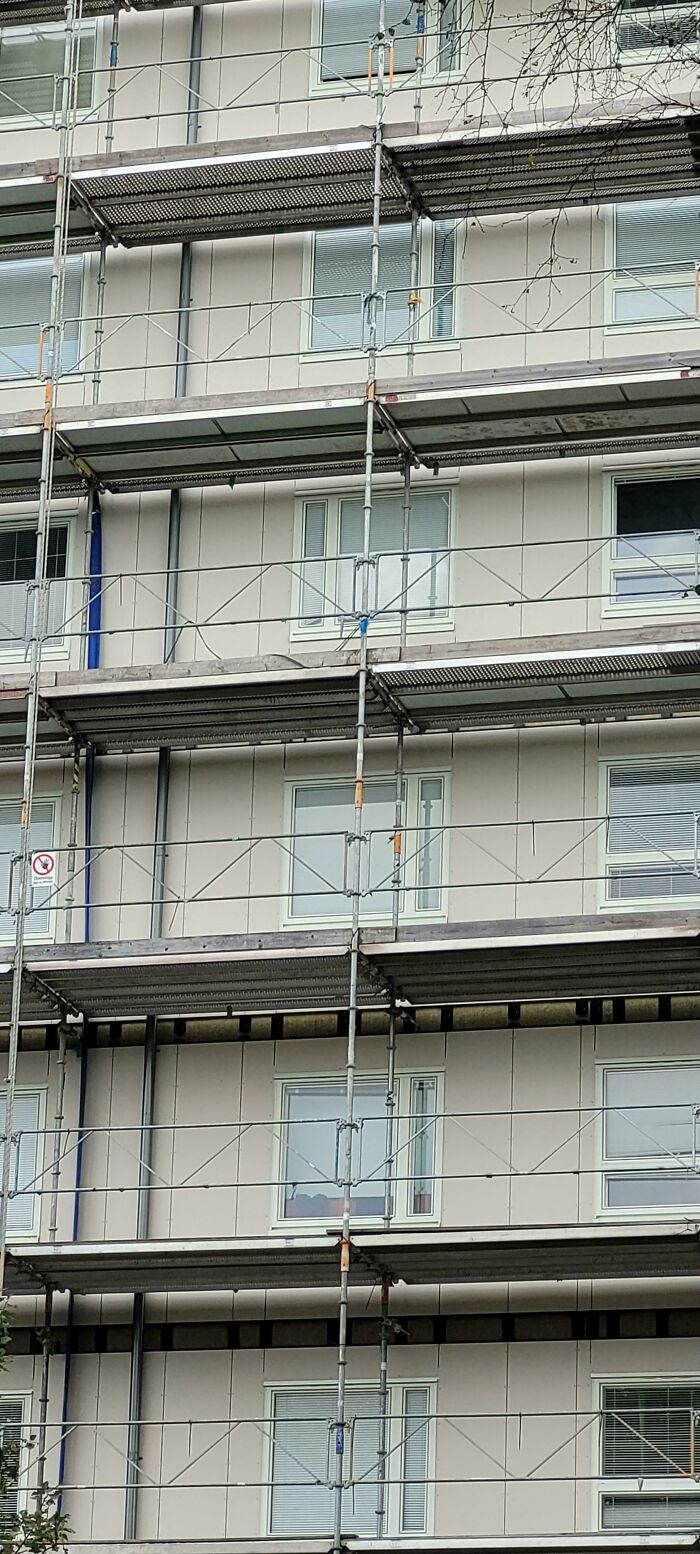 Scaffolding blocking a building door, illustrating a common sense fail from you had one job fails collection.