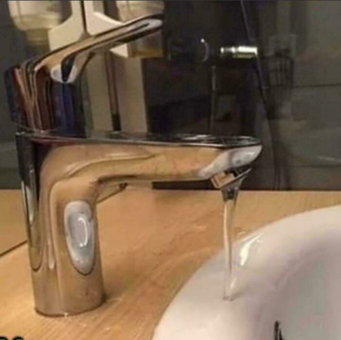 Modern faucet with water flowing incorrectly from the side, showcasing one job fails and lack of common sense design.