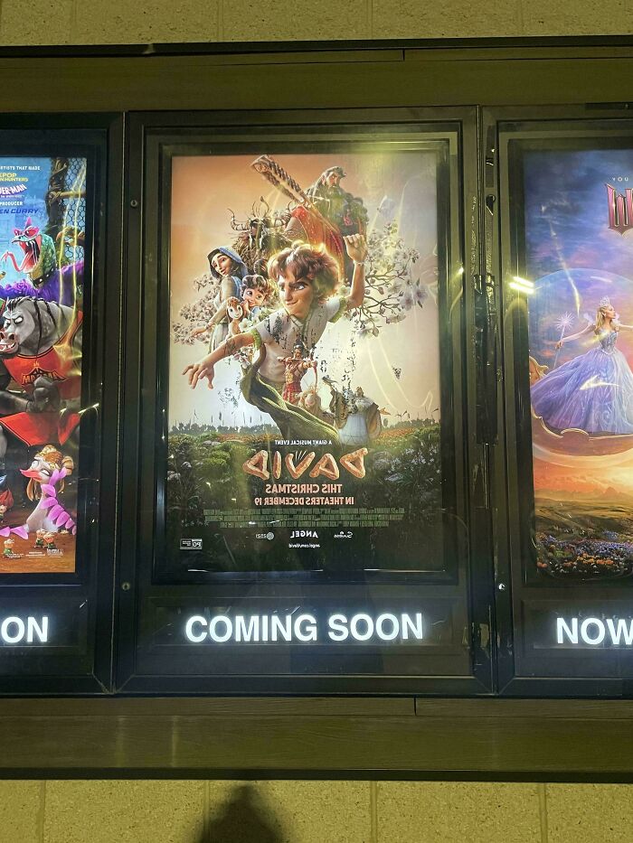 Movie poster displayed upside down in a theater, showcasing one job fail proving common sense isn't common.