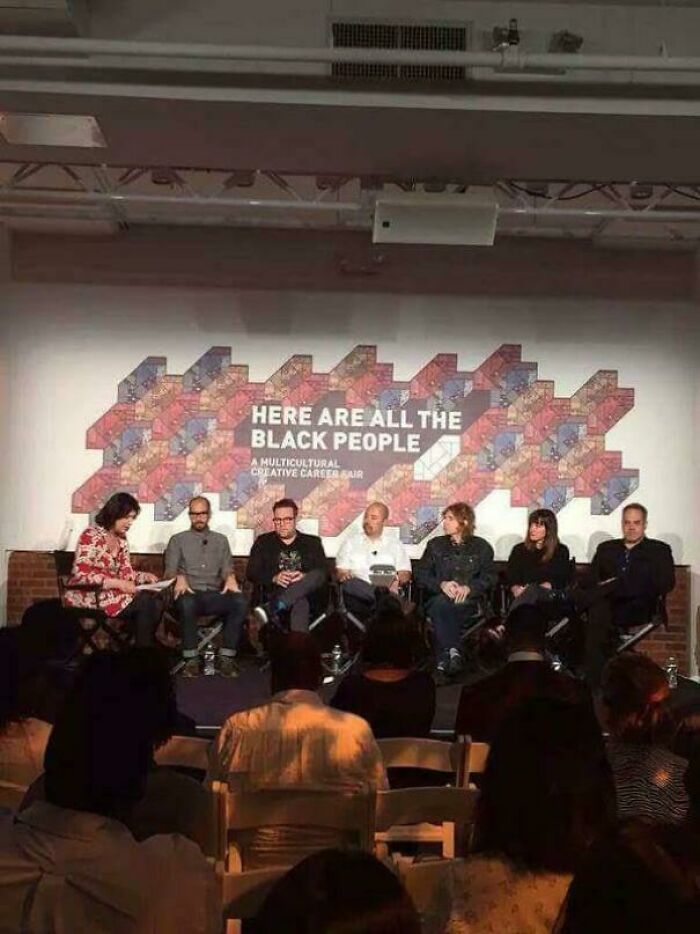 Panel of seven people seated at a discussion event highlighting ridiculous you had one job fails in signage and messaging.