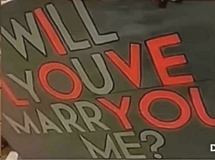 Sign with spelling errors in marriage proposal highlighting a funny you had one job fail showing lack of common sense.