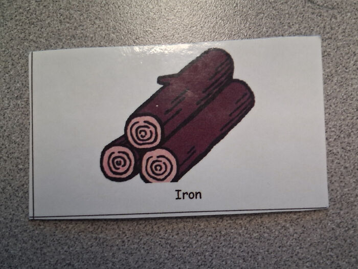 Stack of logs labeled as iron, showcasing a ridiculous you had one job fail and common sense mistake.