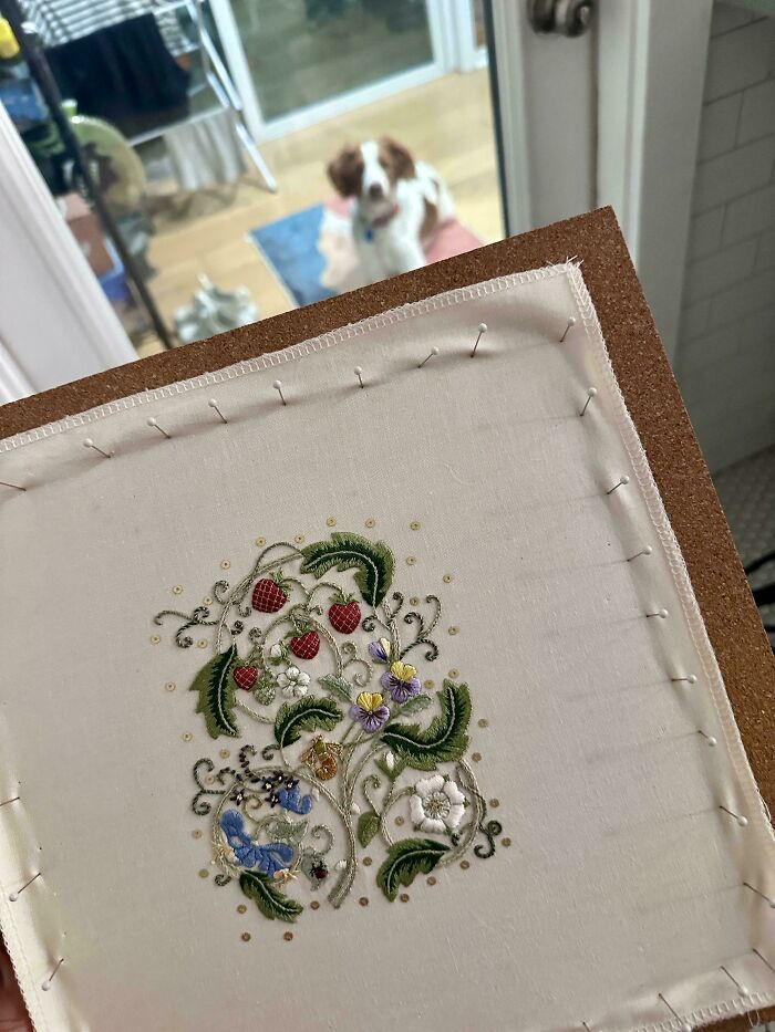 Stunning embroidery creation of strawberries and flowers in progress, inspiring embroidery hobbyists.
