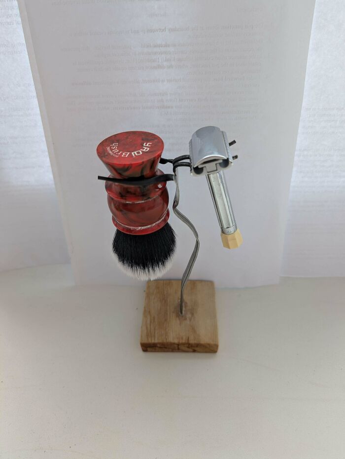 Handmade shaving brush and razor holder made from wood and metal, an example of redneck engineering creativity.