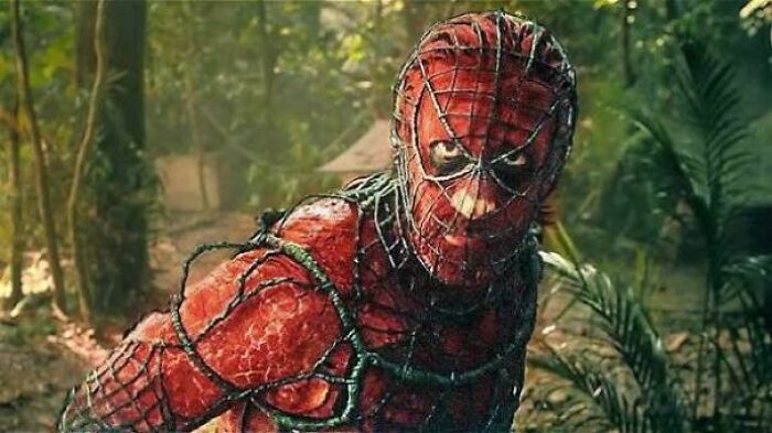 Spider-Man in a red costume tangled in vines in a forest, highlighting hilariously absurd movie and TV details.