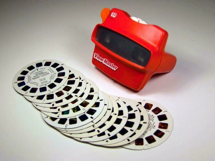 Red View-Master toy with 90s meme reels scanning old childhood memories and nostalgia.