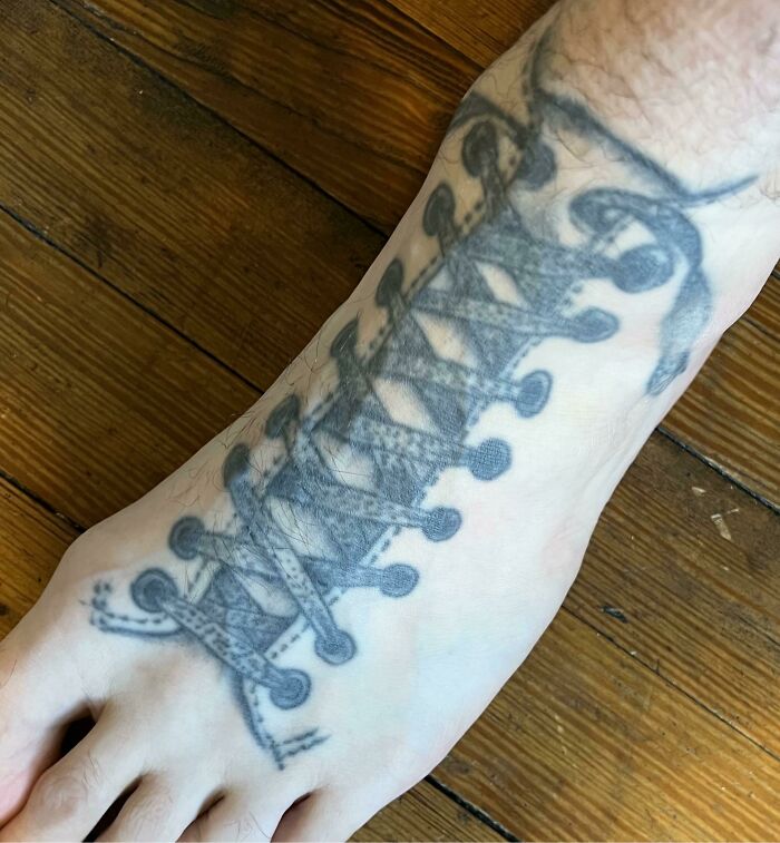 Tattoo of a shoe lace on a foot, showing one of many bad tattoos proving thinking first is optional.