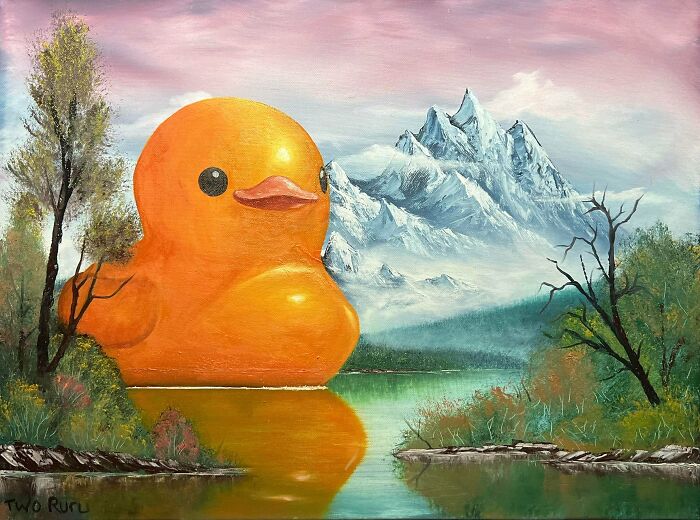 Large orange rubber duck sculpture on a lake surrounded by trees and snow-covered mountains in a DIY art scene.
