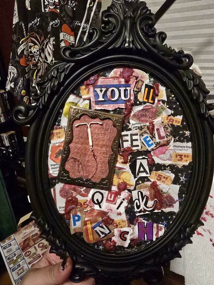 Black ornate frame with a mixed media DIY art piece featuring a contraceptive device and collage of cut-out letters and images.