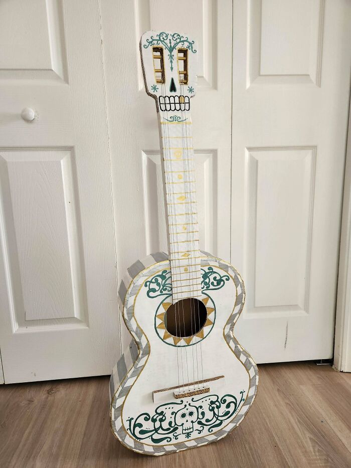 Handcrafted DIY guitar decorated with skull and floral designs, showcasing creative DIY wins and artistic healing projects.