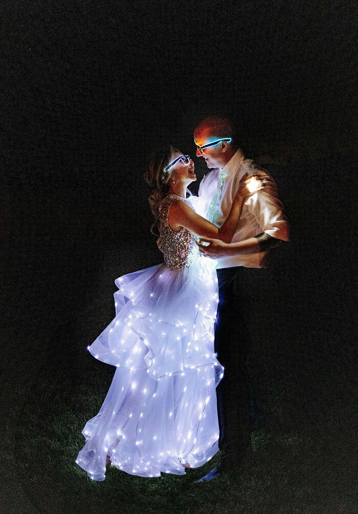 Couple dancing at night wearing glowing LED lights, showcasing creative DIY wins with illuminated clothing and accessories.