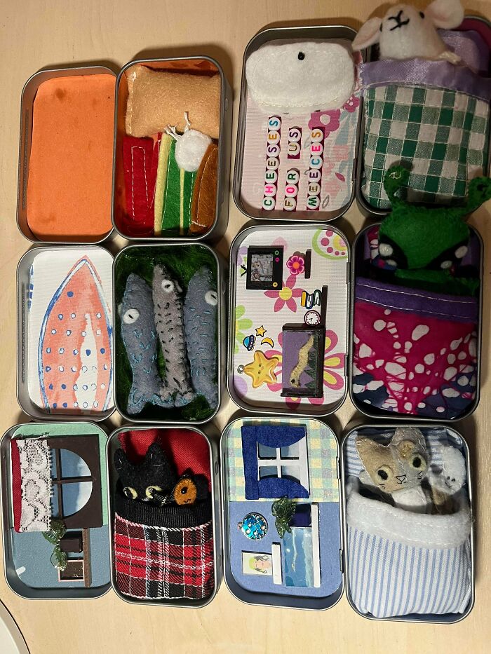 Miniature felt DIY crafts arranged in metal tin boxes showcasing creative handmade projects and DIY wins.