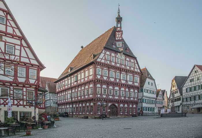Traditional German half-timbered buildings surrounding a town square, displaying beautiful architecture.