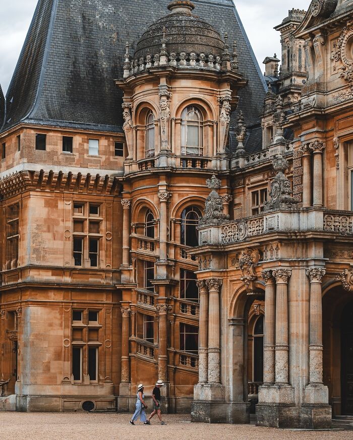 Ornate castle facade with intricate stone carvings and a domed turret, featuring beautiful architecture.