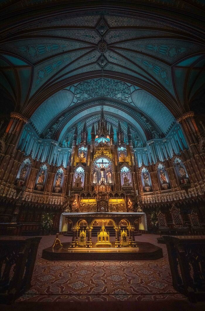 The interior of a church displaying beautiful architecture, featuring an ornate altar and vaulted ceilings.